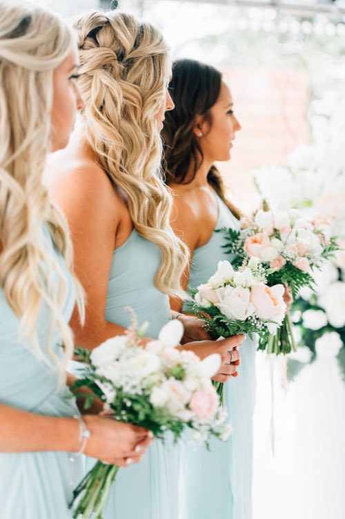 bridesmaids holding arrangements