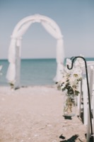 hanging flowers in jar along the beach