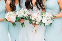 headless bride and bridesmaids, holding arrangements
