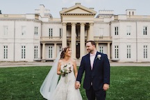 groom and bride infront of castle